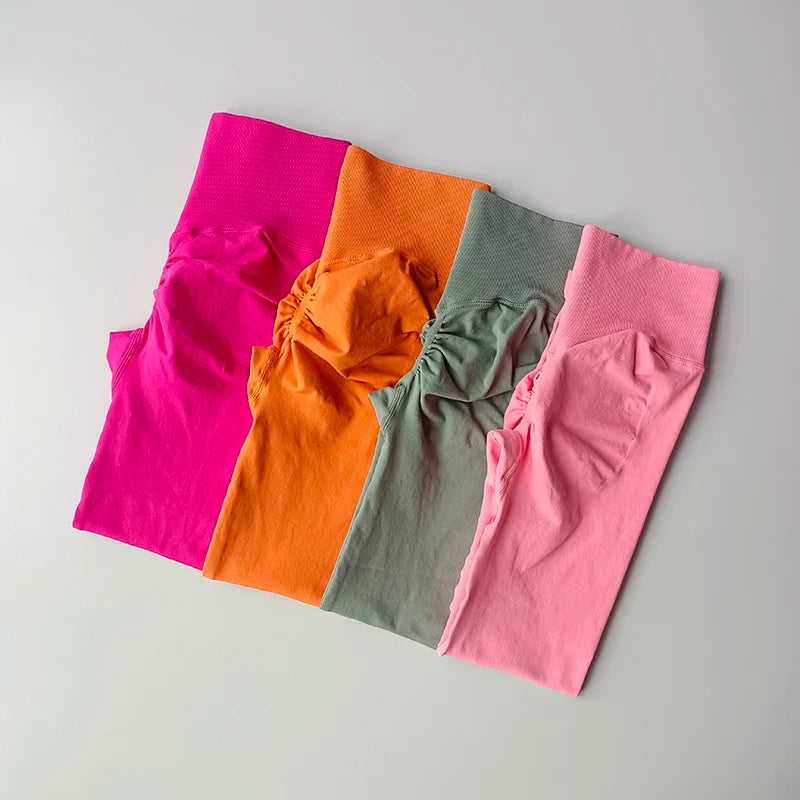 Colorful women hip lift leggings in pink, orange, green, and light pink for stylish workouts