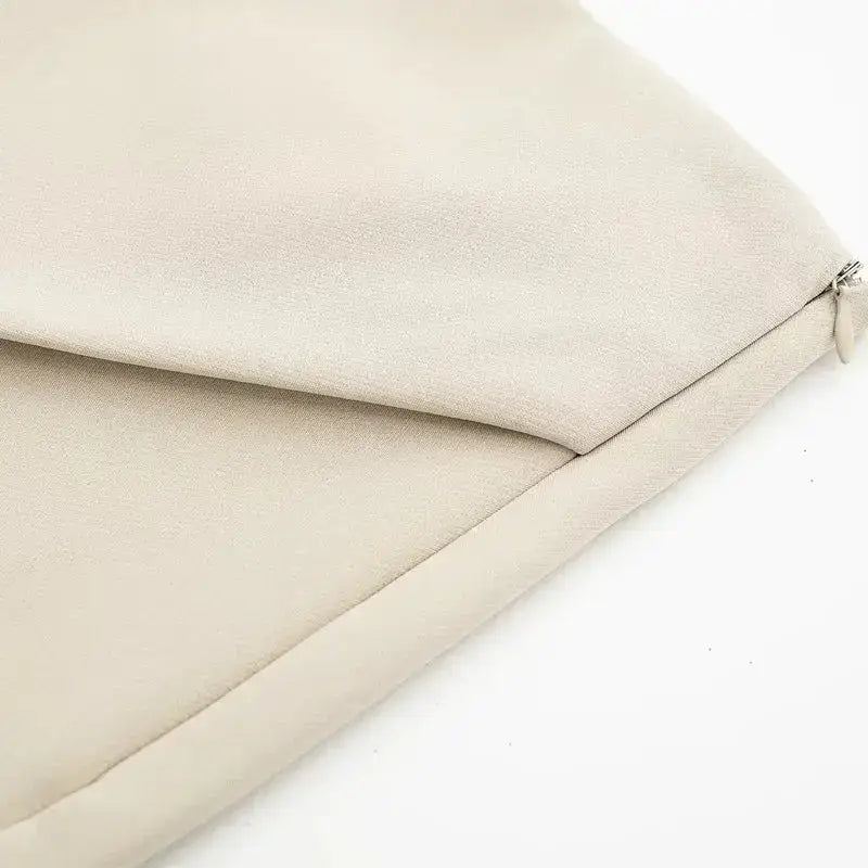 Close-up of beige fabric detail highlighting stitching and texture on fashionable skorts