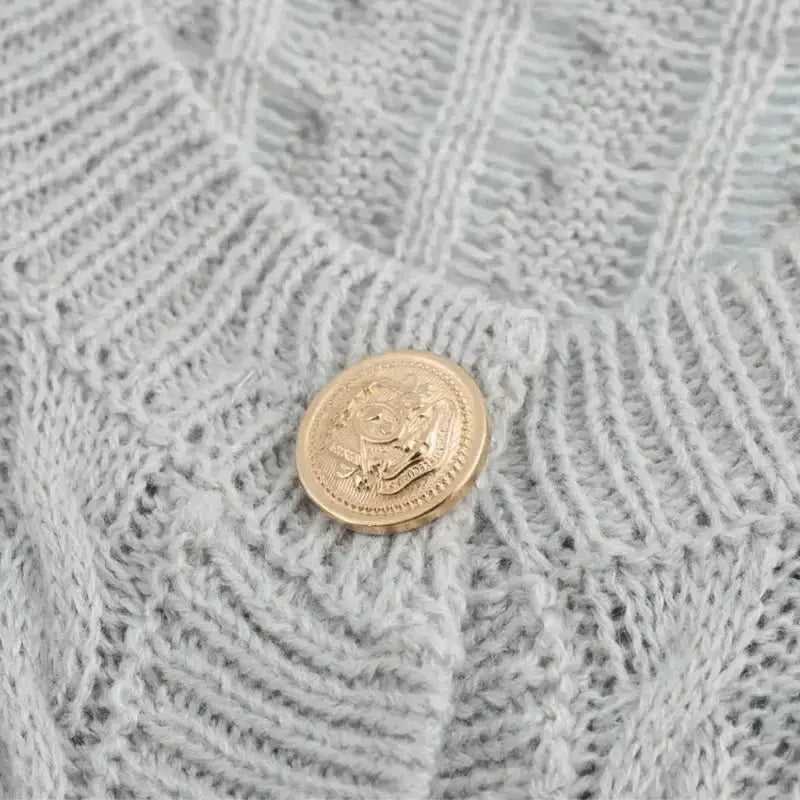 Close-up of a gold button on a Women's Autumn Elegant Cropped Sweater Cardigan from The Lady's Haven Boutique