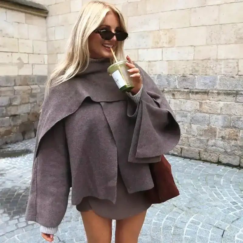 Stylish long sleeve cardigan for ladies in brown worn by a woman drinking a green smoothie outdoors
