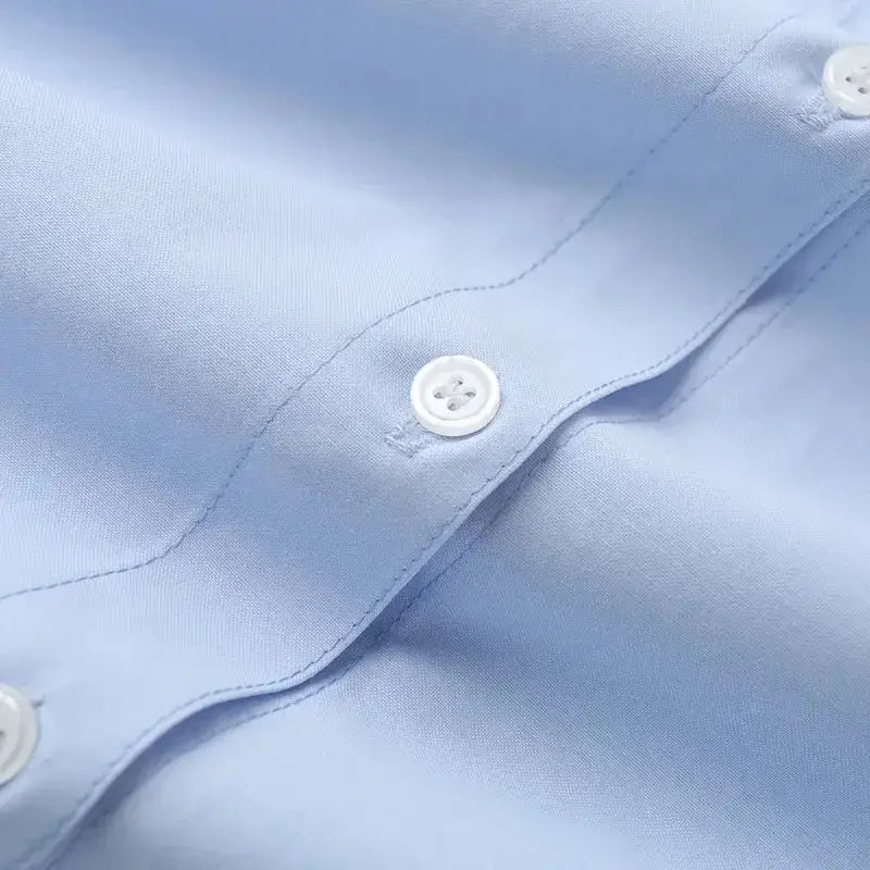 Close-up of light blue spring long sleeve office shirt with white buttons and smooth fabric