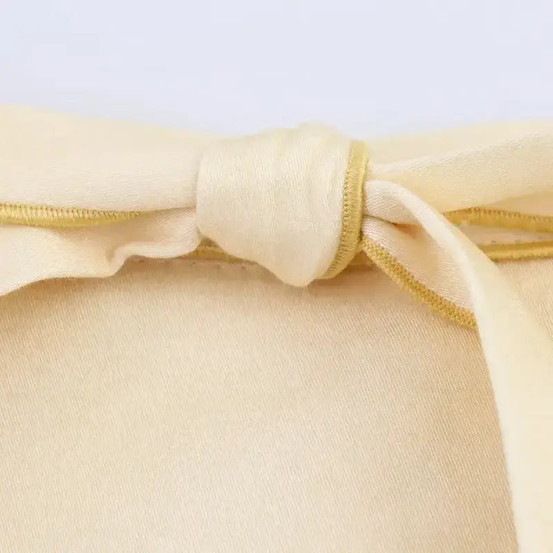 Close-up of beige fabric bow detail on fashion casual skirts with print from The Lady's Haven Boutique