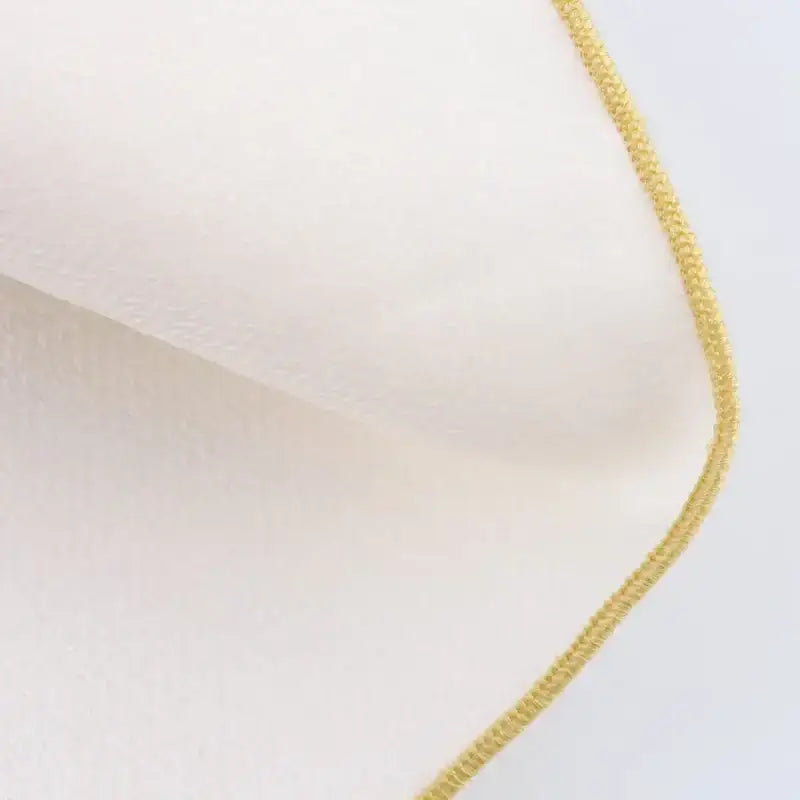 Close-up of fabric texture with yellow stitching detail suitable for fashion casual skirts with print