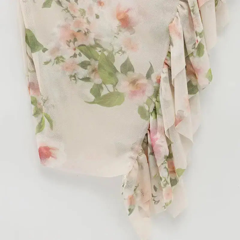 Close-up of floral pattern and ruffle details on sleeveless tie back floral dress from The Lady's Haven Boutique