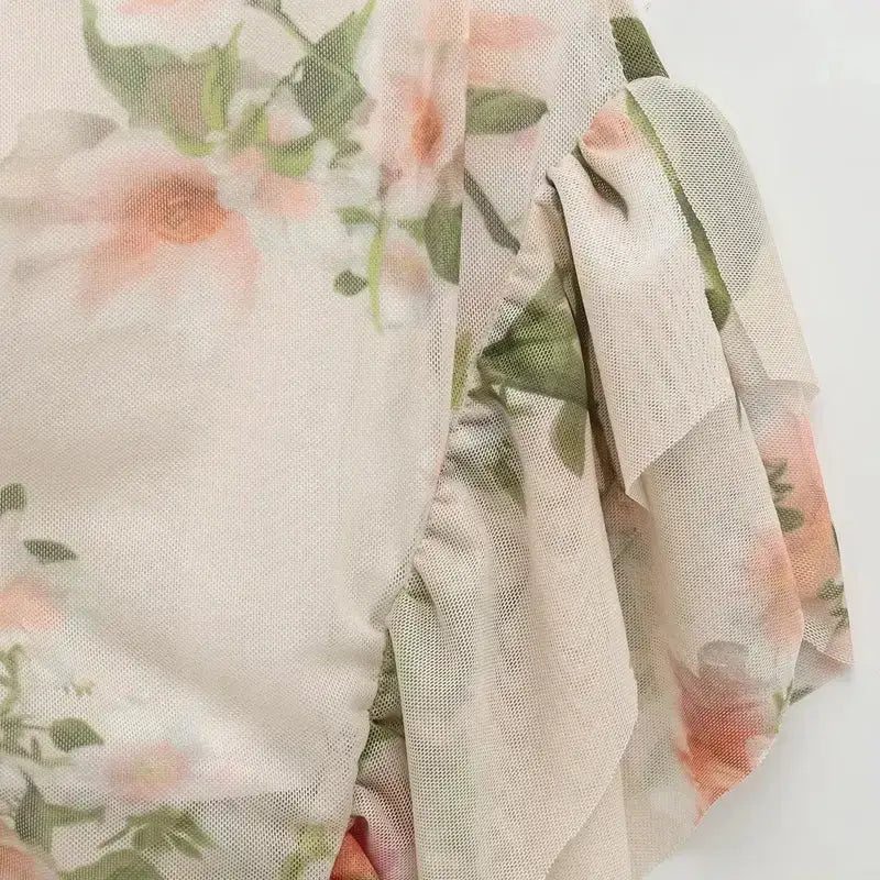 Close-up of floral fabric with sheer overlay on sleeveless tie back floral dress from The Lady's Haven Boutique
