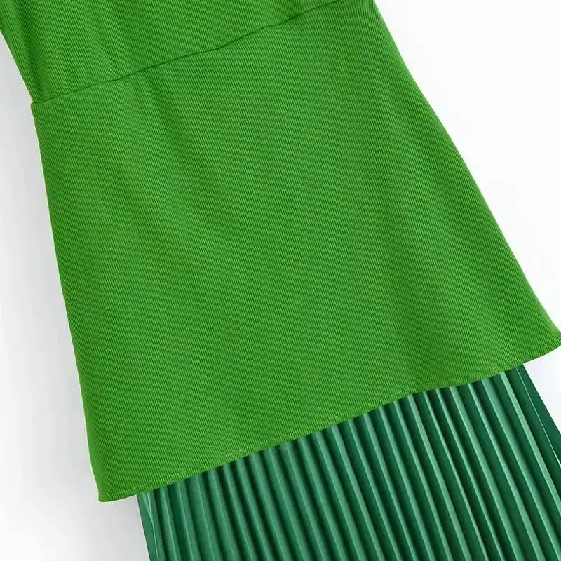 Close-up of sleeveless green maxi dress with textured top and pleated skirt from The Lady's Haven Boutique