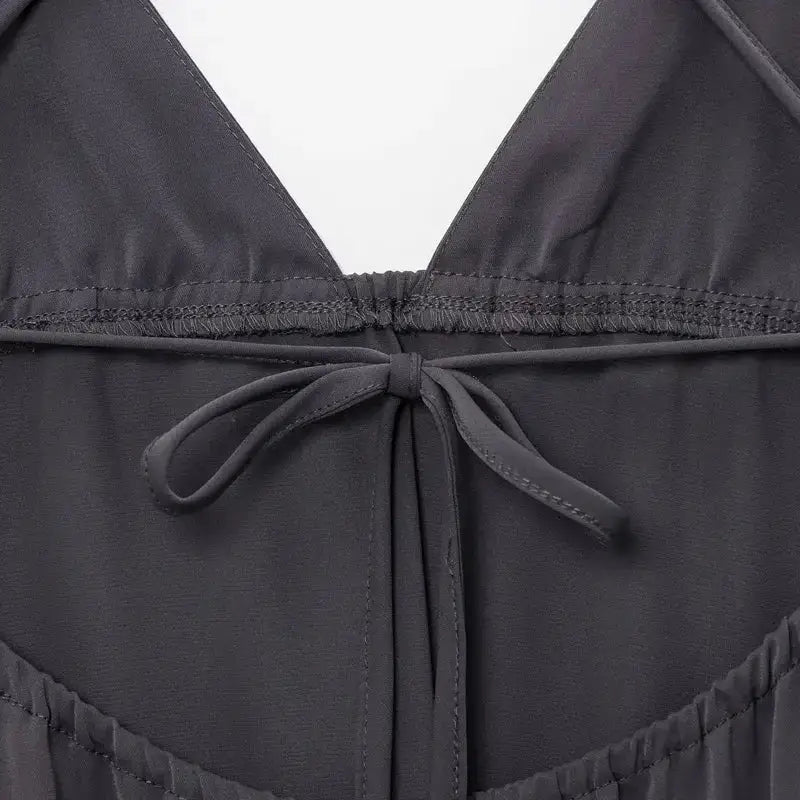 Close-up detail of the back tie on a black sleeveless backless midi dress from The Lady's Haven Boutique
