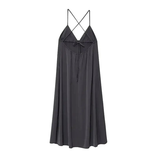 Black sleeveless backless midi dress with thin crisscross straps and flowy fabric from The Lady's Haven Boutique