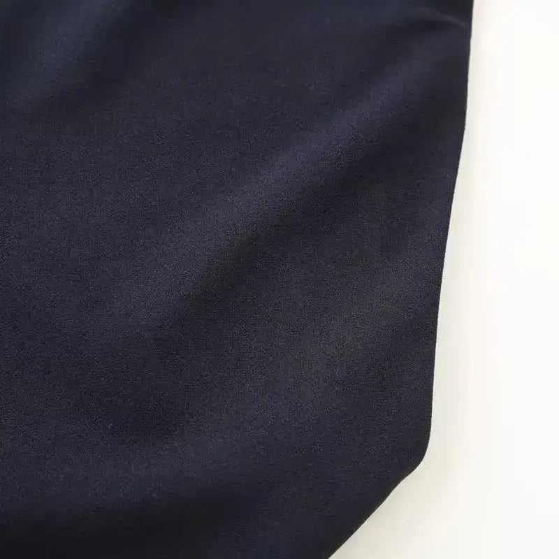 Close-up fabric detail of navy blue formal evening dress from The Lady's Haven Boutique