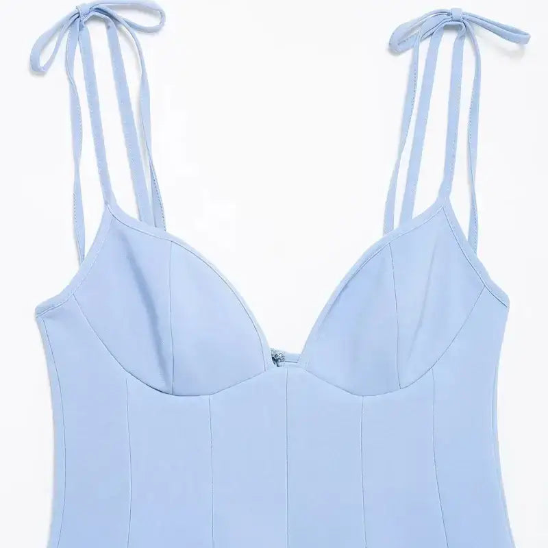 Close-up of a light blue mini party dress with thin adjustable shoulder straps and sweetheart neckline