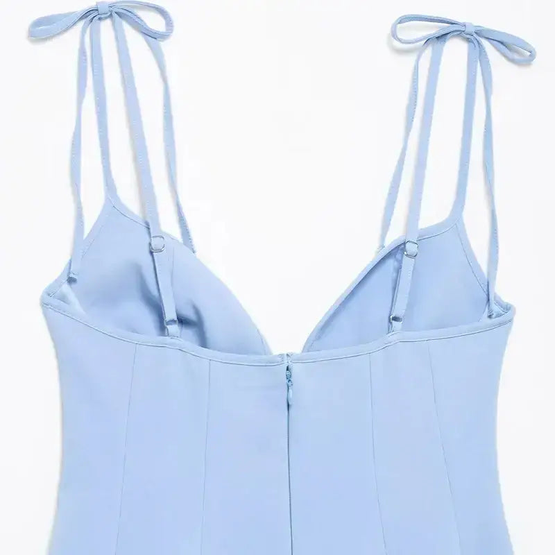 Back view of blue mini party dress with adjustable shoulder ties and zipper closure