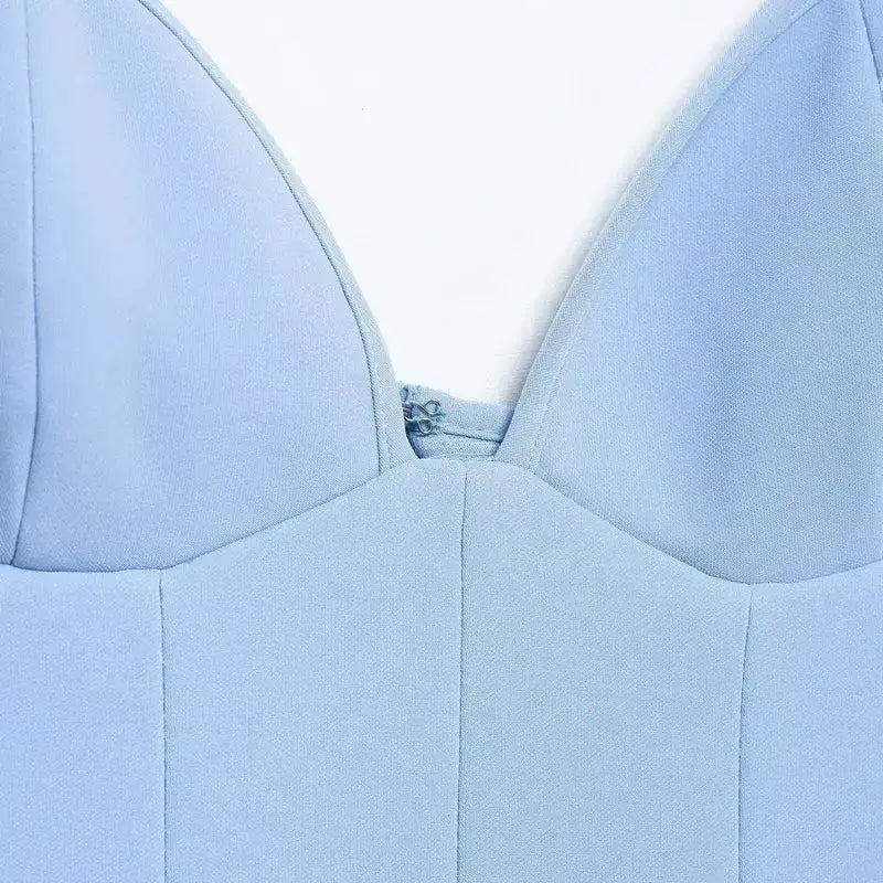 Close-up of blue mini party dress with structured fabric and deep neckline from The Lady's Haven Boutique