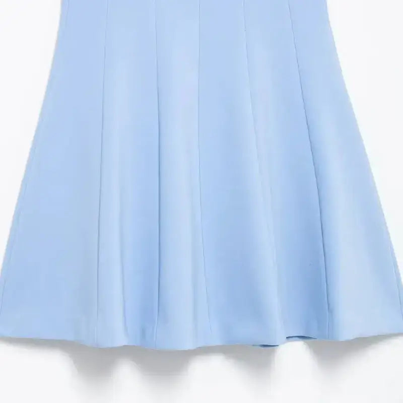 Close-up of a blue mini party dress with smooth fabric and subtle panel detailing
