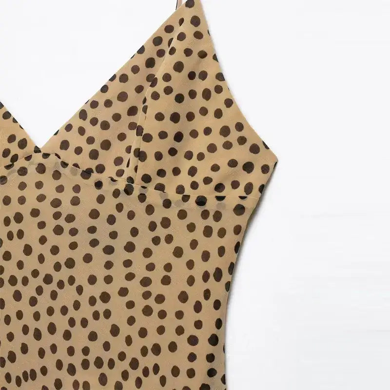 Close-up of elegant polka dot maxi dress in light brown with black dots by The Lady's Haven Boutique