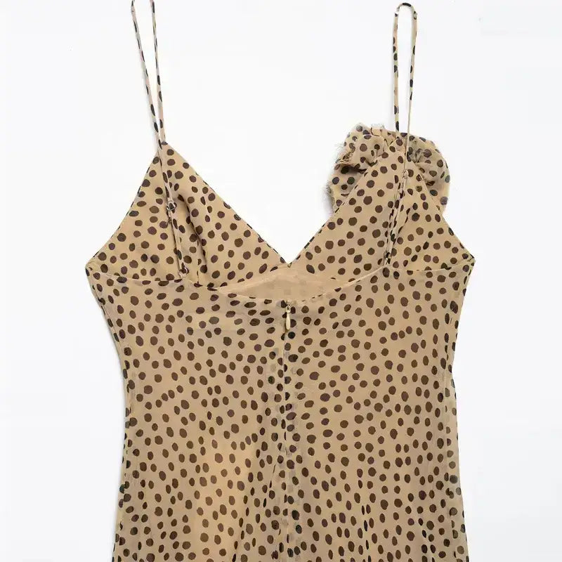 Elegant polka dot maxi dress with thin straps and brown spots on beige fabric