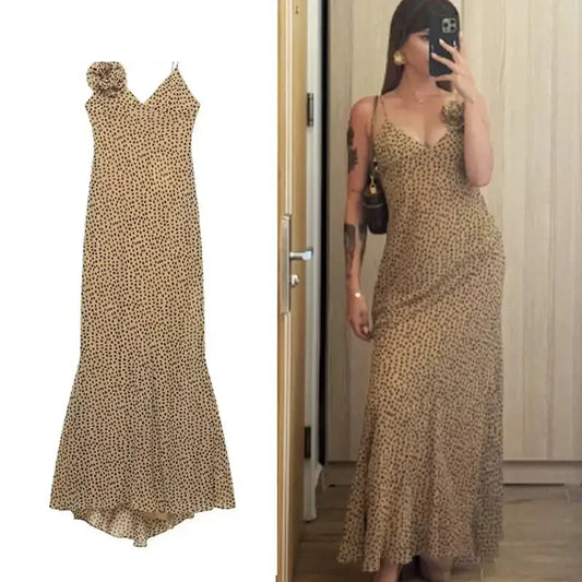 Elegant polka dot maxi dress in beige with black dots featuring thin straps and a fitted waist