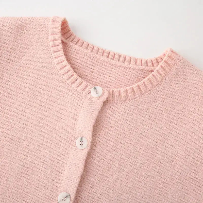 Pink knit fashion lightweight cardigan with round neckline and white buttons from The Lady's Haven Boutique