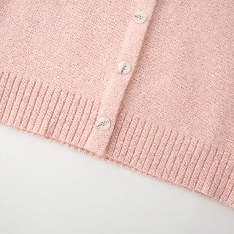 Close-up of soft pink fashion lightweight cardigan with white buttons and ribbed hem by The Lady's Haven Boutique