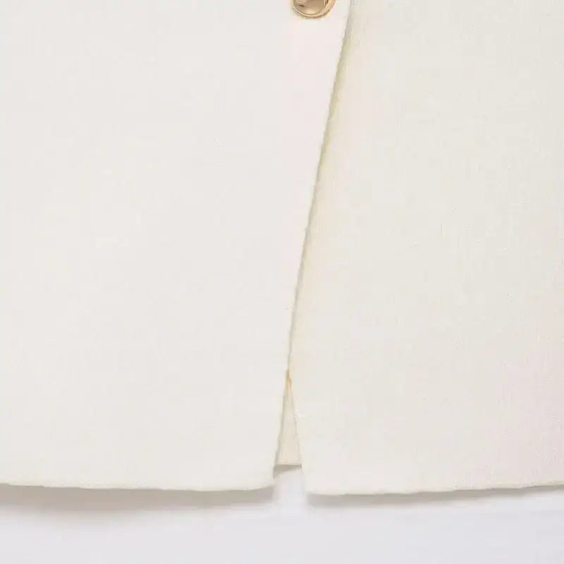 Close-up of white knit crop sweater vest hem detail from The Lady's Haven Boutique