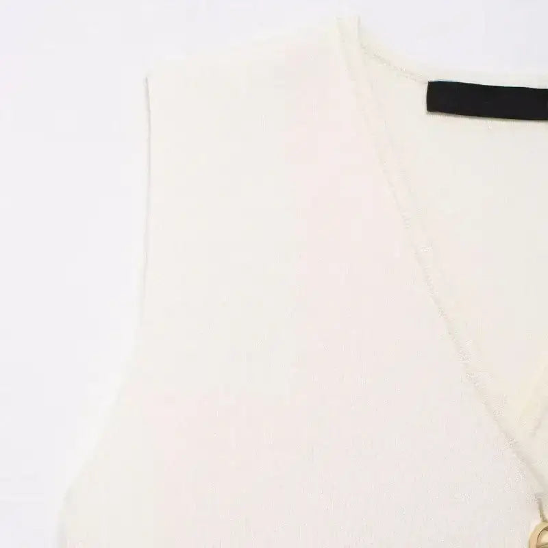 White crop sweater vest with V-neck and sleeveless design from The Lady's Haven Boutique