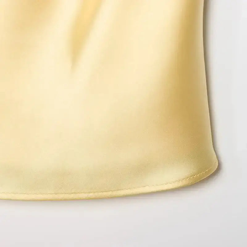 Close-up of soft yellow fabric detail of halter crop tops from The Lady's Haven Boutique