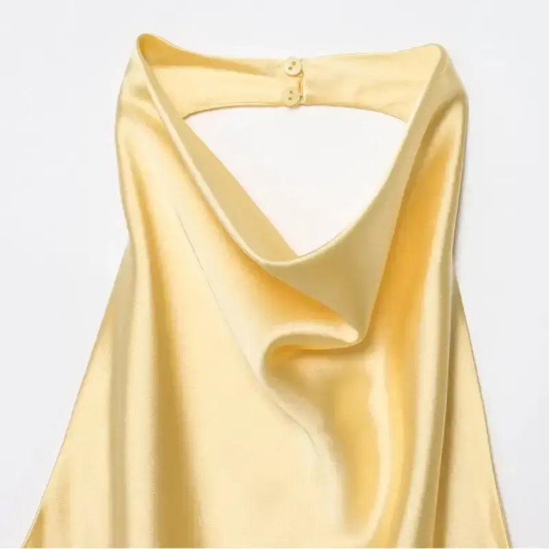 Soft yellow satin halter crop tops with a draped neckline and back button closure