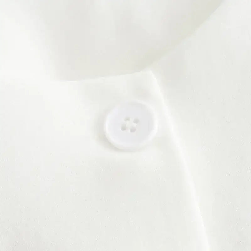 Close-up of white button detail on summer office vest and shorts outfit from The Lady's Haven Boutique