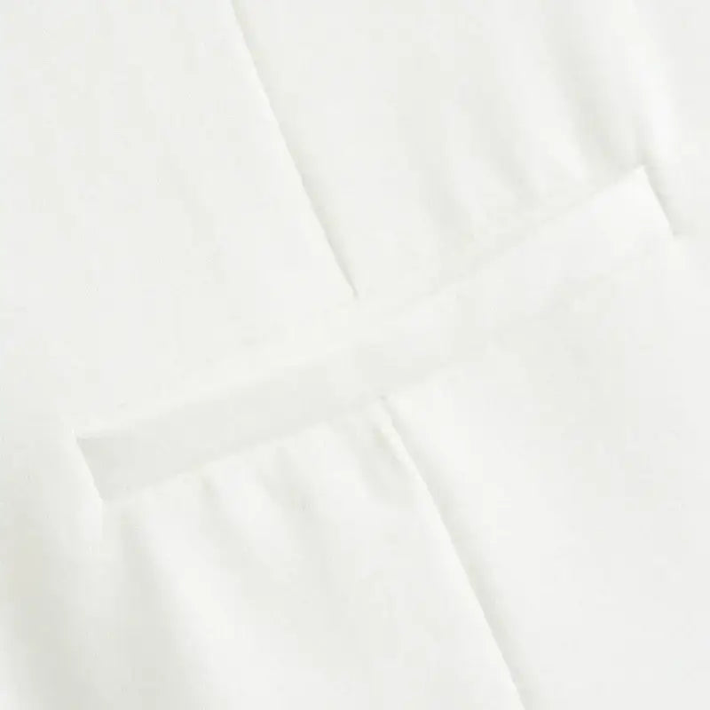 Close up of white fabric detail from summer office vest and shorts outfit by The Lady's Haven Boutique