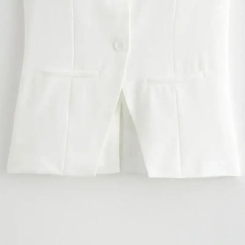 Close up of white tailored vest with pockets from summer office vest and shorts outfit by The Lady's Haven Boutique
