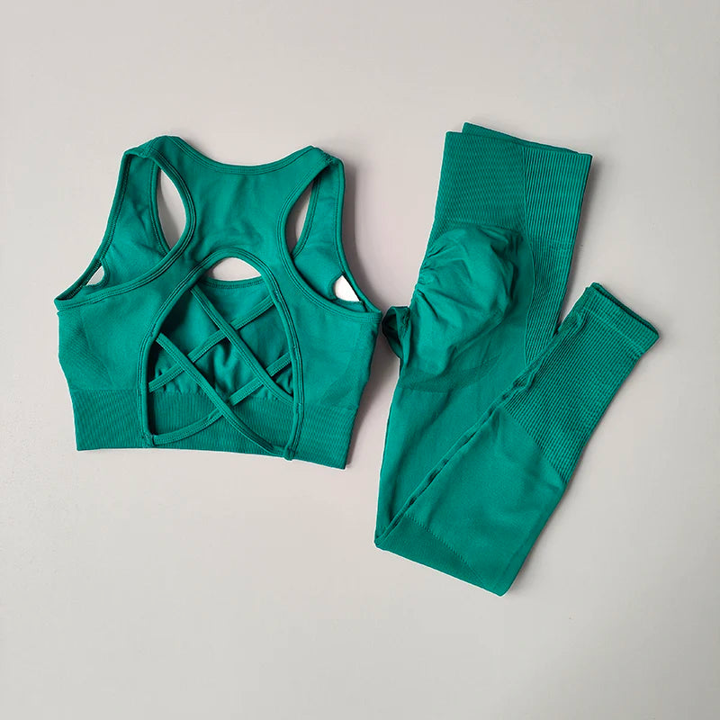 Stylish womens yoga set tracksuit in teal with a crisscross sports bra and matching leggings