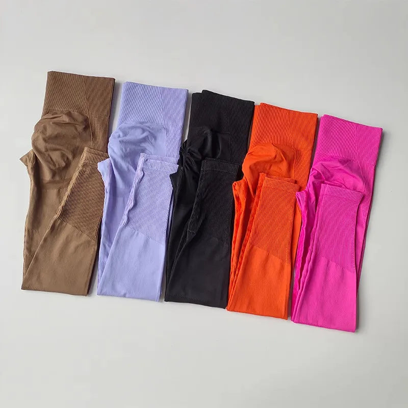 Collection of womens yoga set tracksuit leggings in various colors including brown, lilac, black, orange, and pink