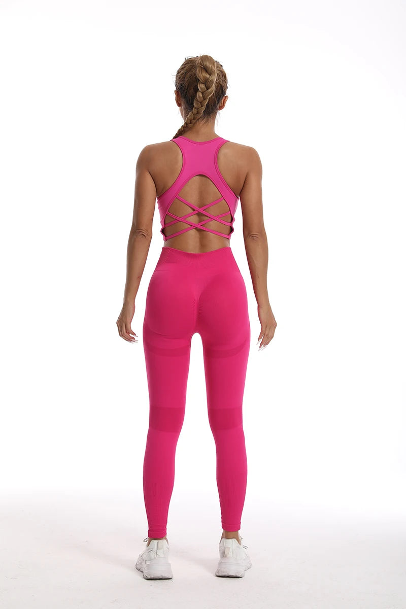 Back view of a pink womens yoga set tracksuit featuring a stylish crisscross design and fitted leggings