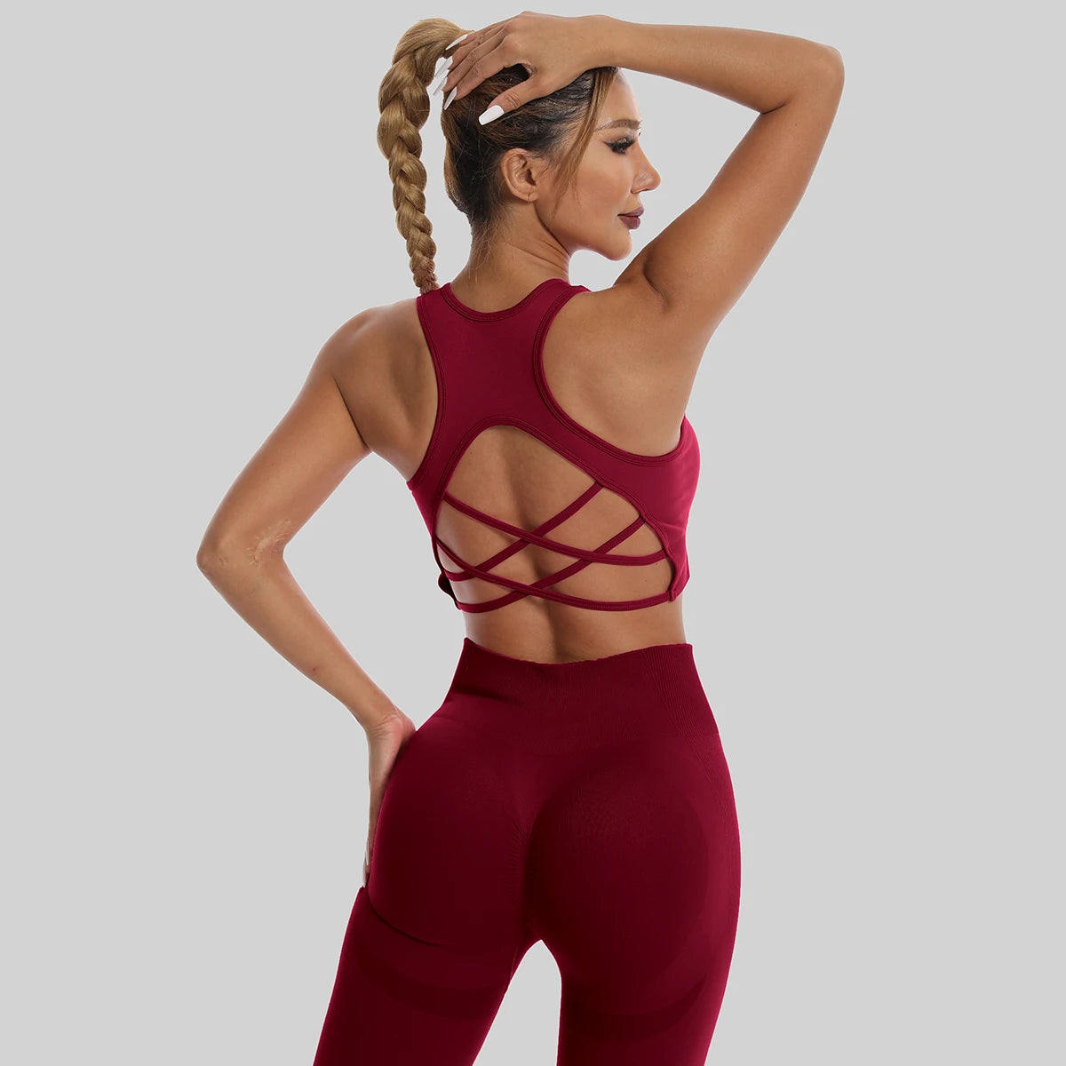 Womens yoga set tracksuit in burgundy with stylish crisscross back design for comfortable workouts
