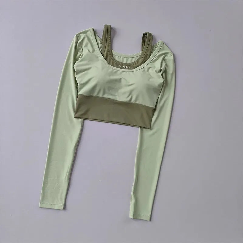Light green workout t-shirt with pads featuring long sleeves and a cropped design for activewear.