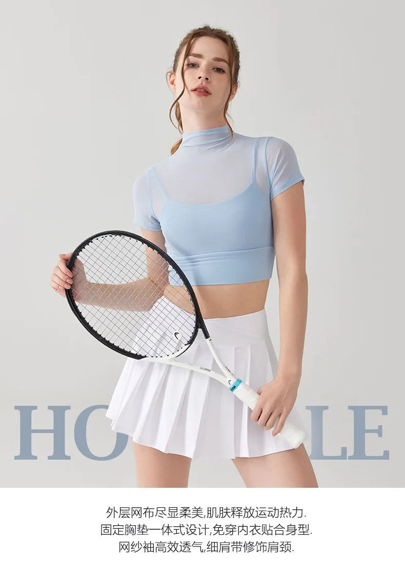 Stylish yoga clothes for women featuring a light blue crop top and white pleated skirt for activewear
