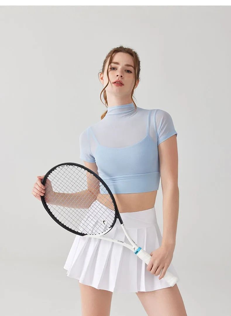 Light blue crop top paired with a white tennis skirt, ideal yoga clothes for women