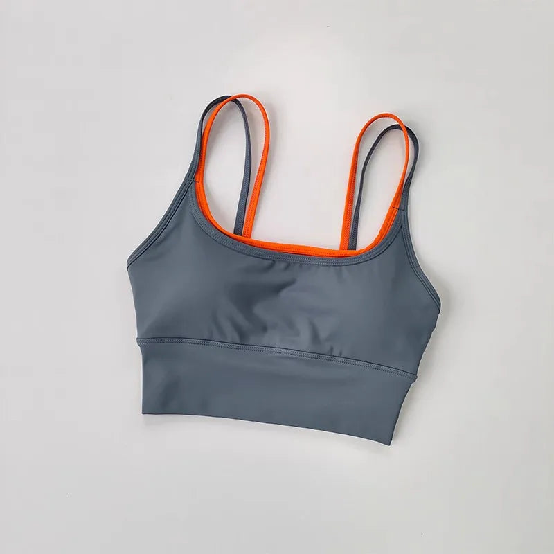 Gray yoga crop top for workout with orange straps, ideal for flexibility and comfort during exercises