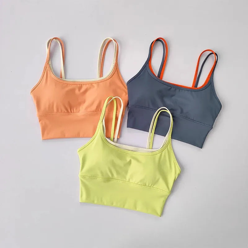 Three stylish yoga crop tops for workout in orange, gray, and neon green colors