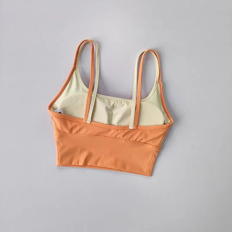 Two-tone orange and beige yoga crop top for workout with adjustable straps and a stylish fit