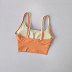 Two-tone orange and beige yoga crop top for workout with adjustable straps and a stylish fit