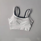 Stylish white yoga crop top for workout with black straps for optimal comfort and support