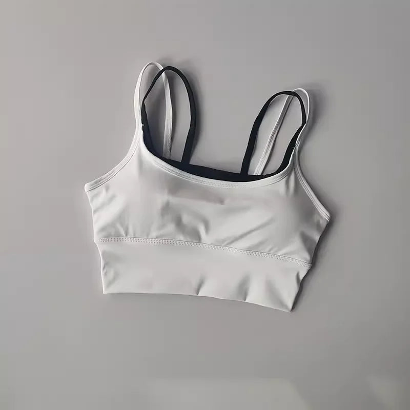 Stylish white yoga crop top for workout with black straps for optimal comfort and support