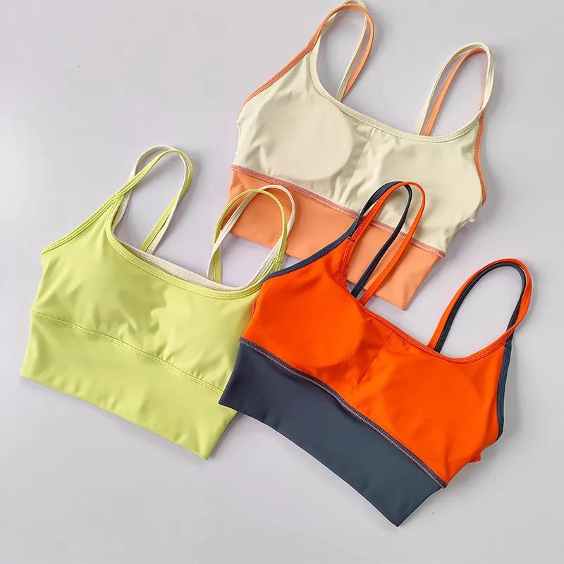 Three stylish yoga crop tops for workout in vibrant colors: yellow, orange, and cream