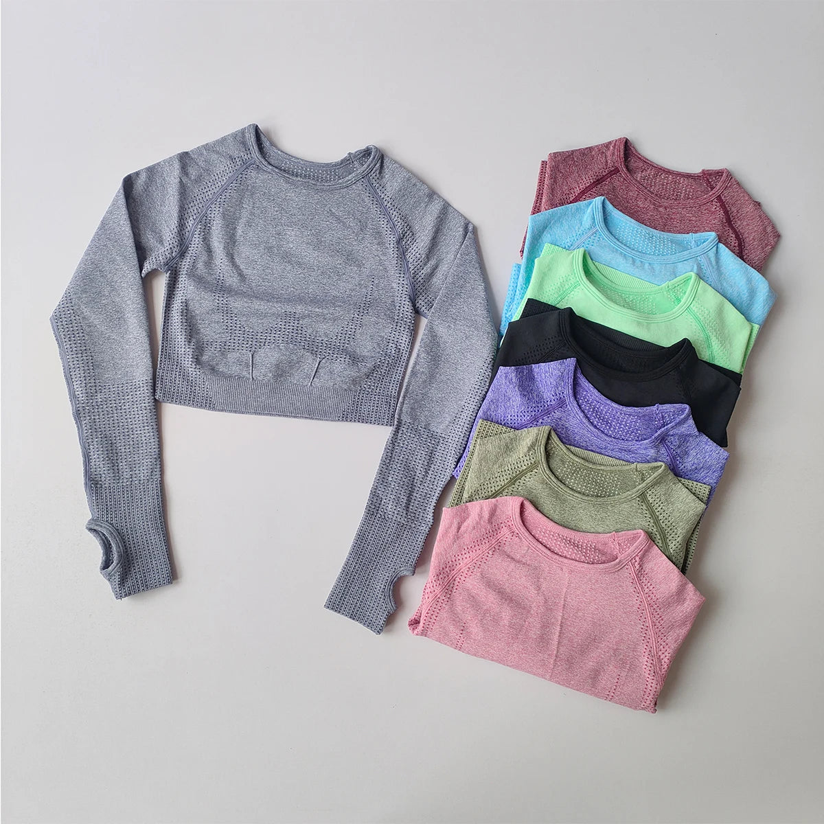 Collection of yoga fitness tops for women in various colors and styles displayed on a neutral background