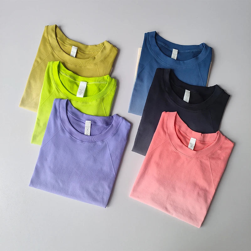 Colorful yoga top and shorts gradient for women in various shades laid out on a light background